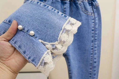 Blue girls' jeans with loose flare design, lace trim, and pearl button details for children aged 3-12 years.