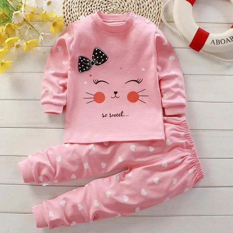 Pink autumn sleepwear pajamas for kids with long sleeves and heart pattern pants, featuring a cute cartoon cat face and bow design