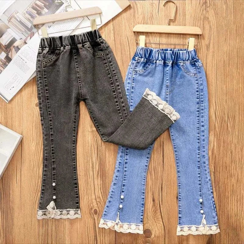 Girls' jeans for girls with loose flare legs, elastic waist, lace and pearl trim at the hem in black and blue denim colors.