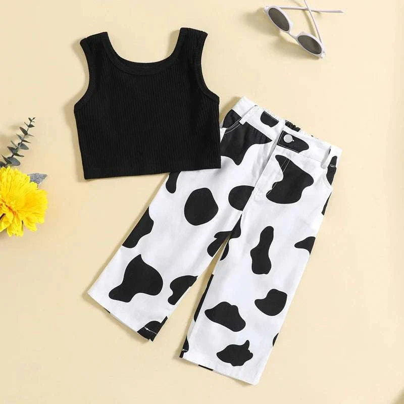 Kids girls summer outfit with black ribbed sleeveless tank top and white elastic cow print pants set