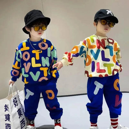 Two boys wearing colorful autumn cotton letter print pullover sweatshirts and matching blue sweatpants children's clothes set, accessorized with black hats and sunglasses.
