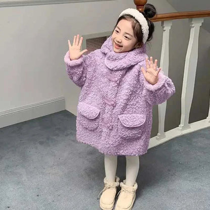 Toddler girl wearing a trendy purple plush jacket with hood and large buttons, styled for autumn and winter.