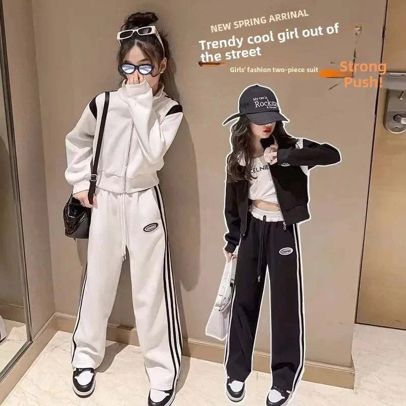 Two girls wearing the 2024 Kids' Autumn/Winter sporty casual two-piece clothing set in black and white colors with striped sporty design.