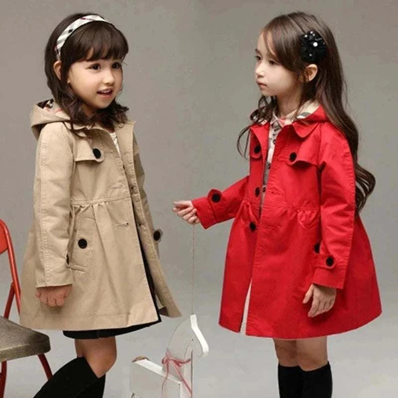 Two young girls wearing spring autumn hoodied windbreaker jackets, one in beige and one in red, standing against a plain background.
